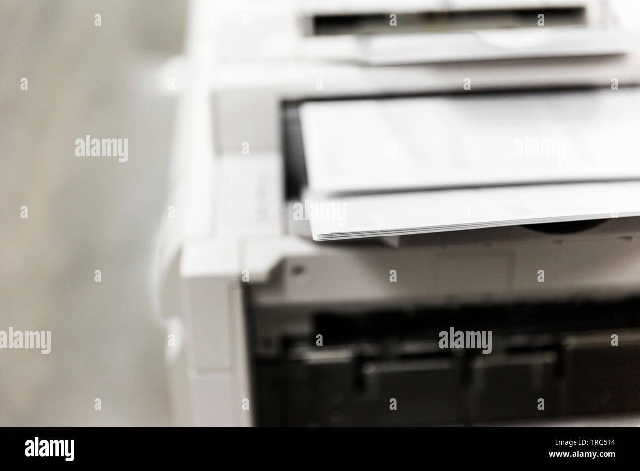 Office printer printing out documents quickly into ordered stack Stock