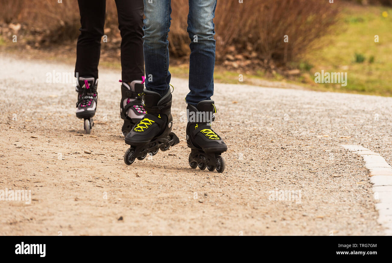 Two persons skating on gravel ground Stock Photo Alamy
