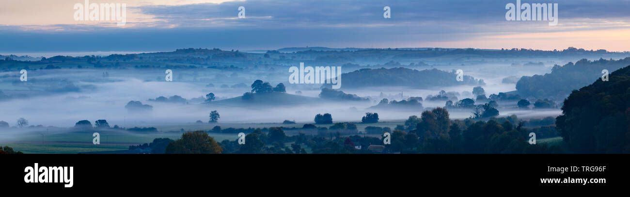 A misty autumnal dawn over Compton Pauncefoot from Cadbury Castle, South Somerset, England. Stock Photo