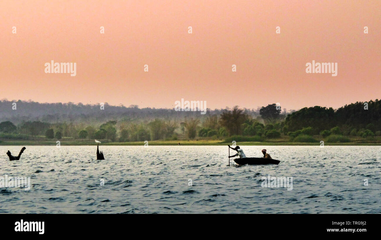 2 people are rowing a dinghy upstream at dusk, India Stock Photo Alamy