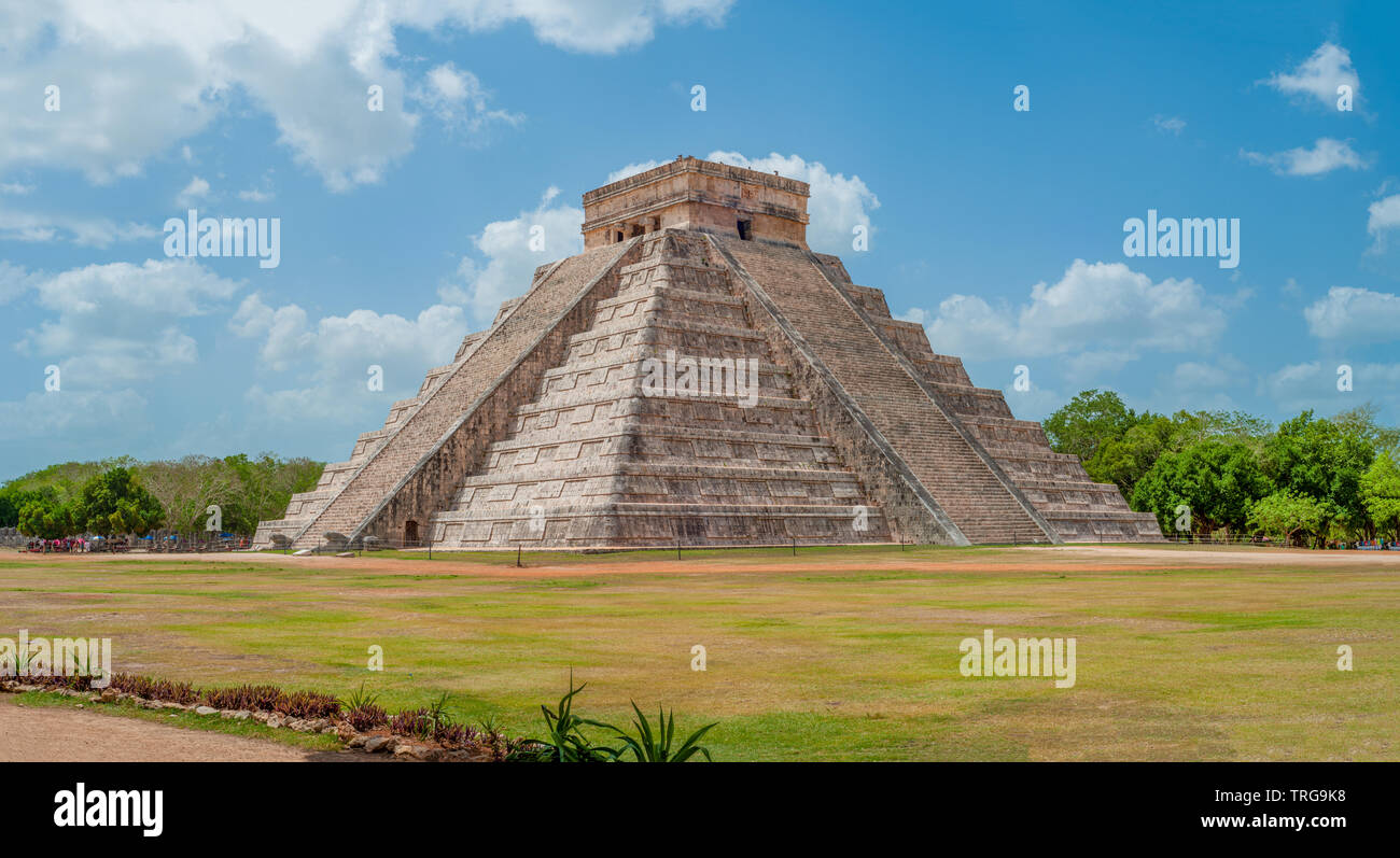 Great Mayan Pyramid of Kukulkan, known as El Castillo, classified as Structure 5B18, taken in the archaeological area of Chichen Itza, between trees a Stock Photo