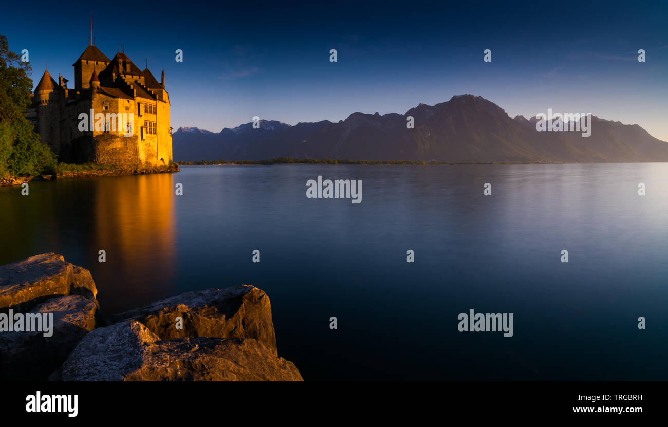 Montreux, VD / Switzerland - 31 May 2019: the historic Chillon Castle on the shores of Lake Geneva at sunset Stock Photo