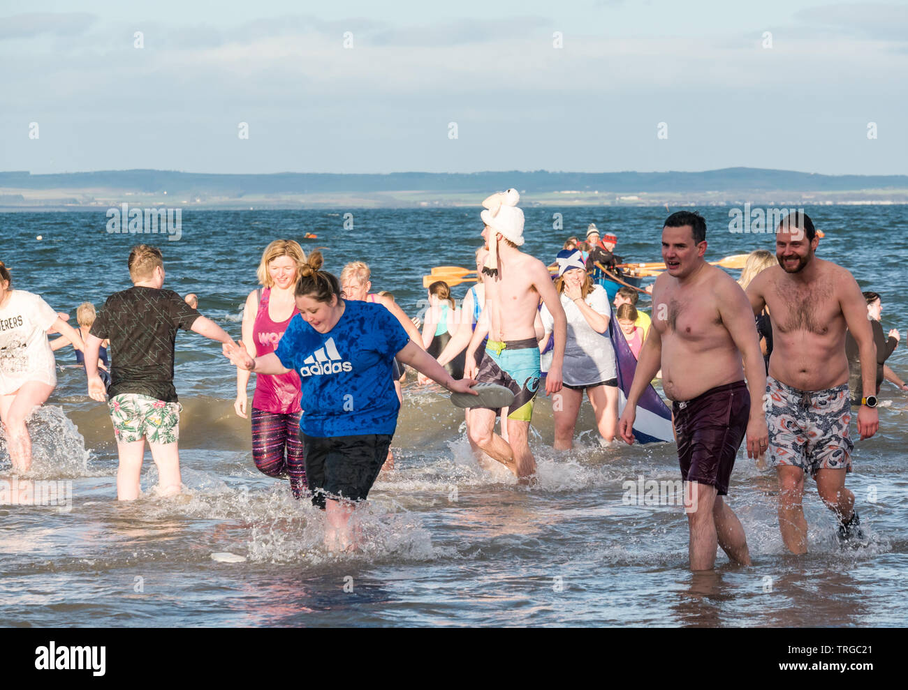 Loony Dook , New Year's Day: People brave the cold water, West Bay, Firth of Forth, North Berwick, East Lothian, Scotland, UK. People run into the sea Stock Photo