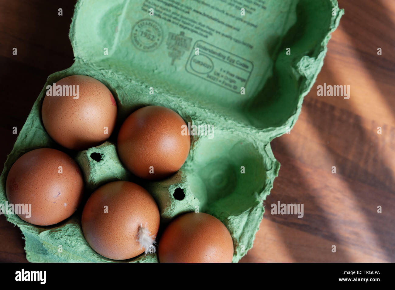 Free range eggs in an open egg box. Stock Photo