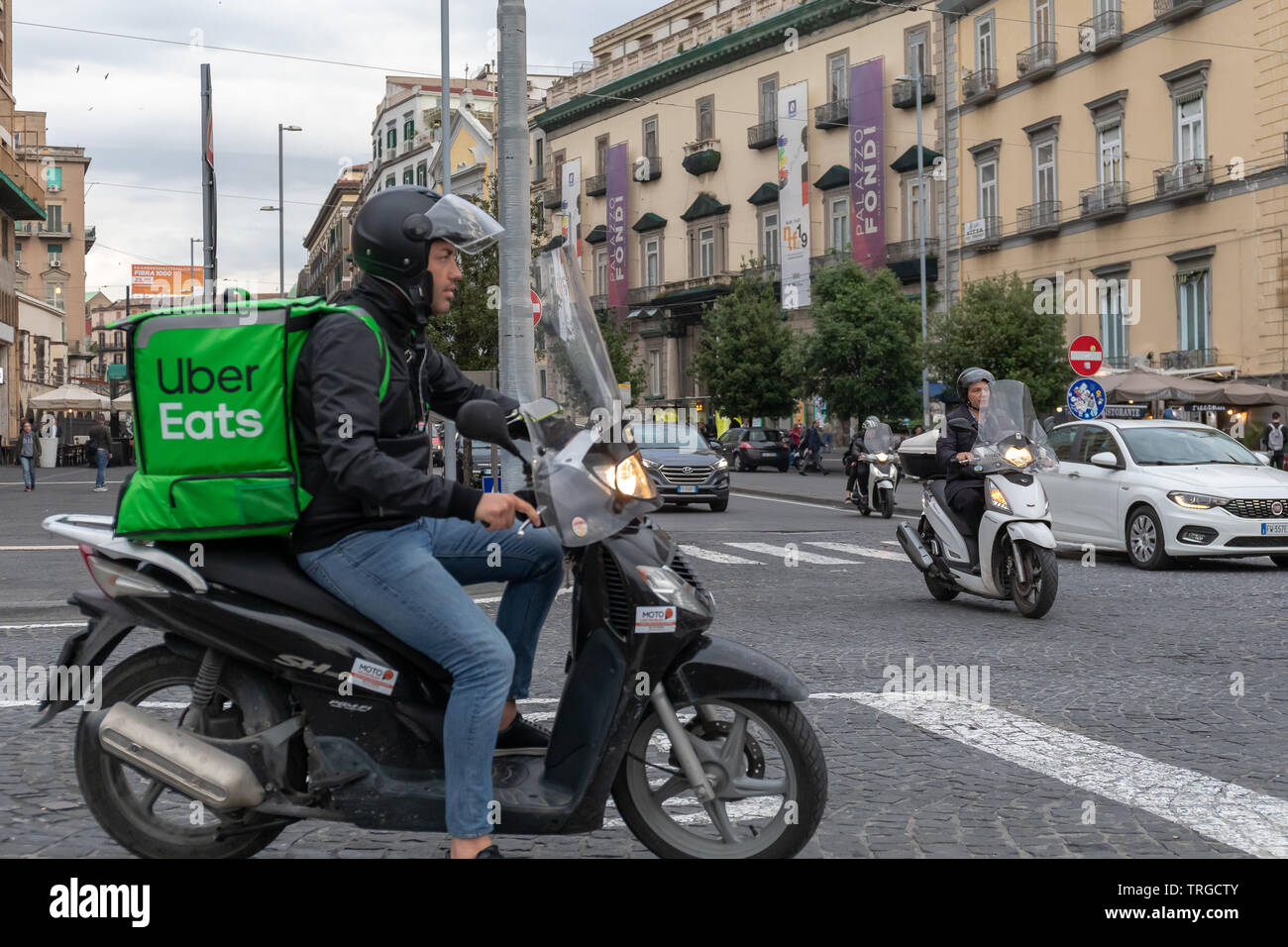 Naples, Italy - May 31, 2019: Uber Eats, a boy with a scooter with the  typical green backpack, delivers food at home Stock Photo - Alamy