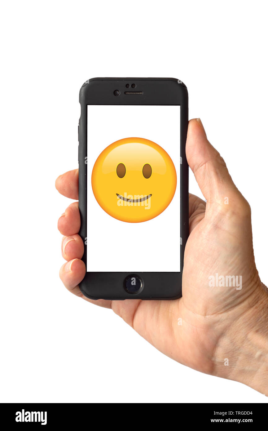 Smile emoji face on a smartphone screen Stock Photo