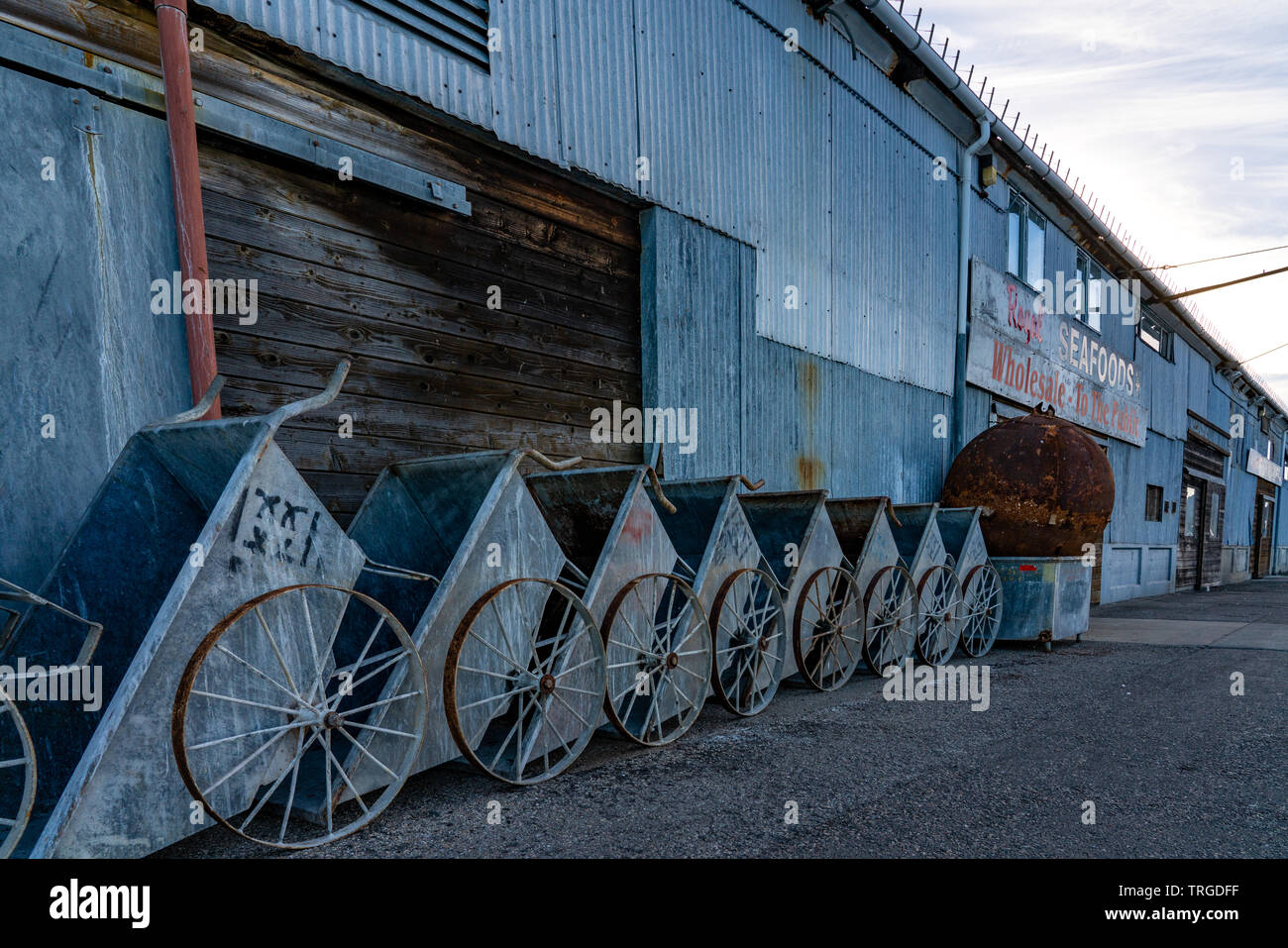 Old Wagon bins lined up along side the Monterey Fish Company building on a pier in Monterey Bay, California. Stock Photo
