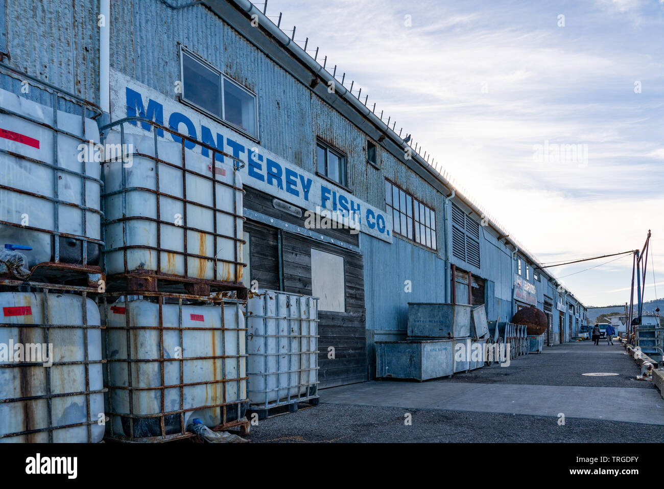 Old rusty containers stacked on the side of the Monterey Fish Company Building along the Pier in Monterey Bay, California. Stock Photo
