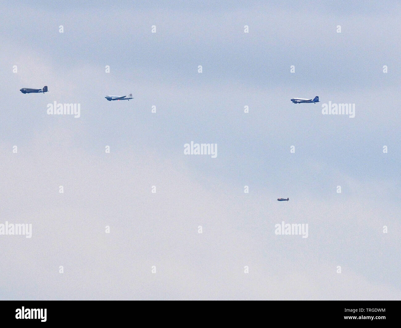 Sheerness, Kent, UK. 5th June, 2019. Daks over Normandy: for the 75th anniversary of the D-day landings - 35 DC-3/C47s took to the skies travelling from Duxford Airfield in the UK to the landing beaches of Normandy. The formation seen here passing Sheerness in Kent on the Isle of Sheppey after flying over Southend on sea in Essex. The Isle of Sheppey is known as the birthplace of British aviation. Credit: James Bell/Alamy Live News Stock Photo