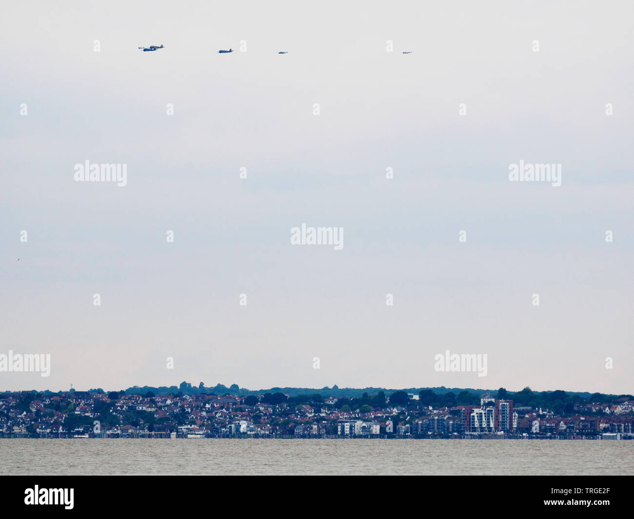 Sheerness, Kent, UK. 5th June, 2019. Daks over Normandy: for the 75th anniversary of the D-day landings - 35 DC-3/C47s took to the skies travelling from Duxford Airfield in the UK to the landing beaches of Normandy. The formation seen here passing Sheerness in Kent on the Isle of Sheppey after flying over Southend on sea in Essex. The Isle of Sheppey is known as the birthplace of British aviation. Credit: James Bell/Alamy Live News Stock Photo