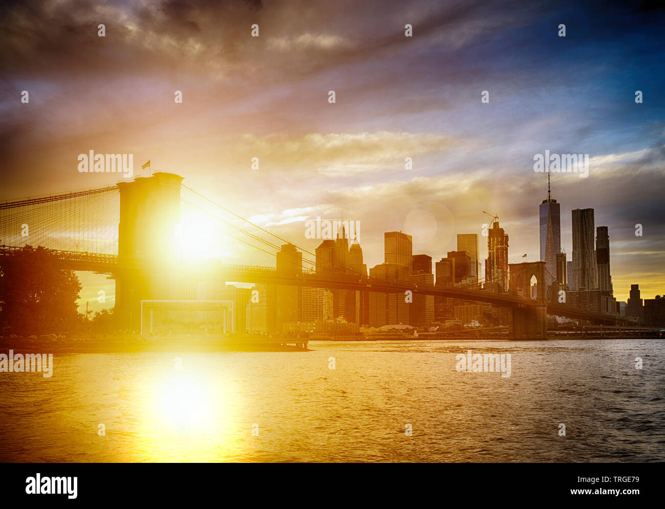 Beautiful sunset over a Brooklyn Bridge in New York City Stock Photo ...
