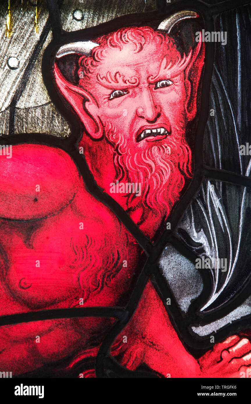 Portrait representing The Devil, in stained glass. Detail of a window in Saint Andrew’s Church in the Dorset village of West Stafford. England. UK. Stock Photo