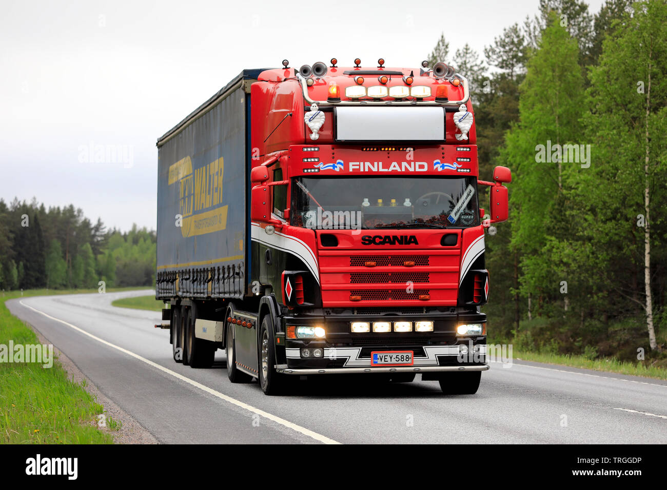 Raasepori, Finland. May 24, 2019. Beautifully customized 4-series Scania truck pulls trailer on highway in South of Finland,with headlights on briefly Stock Photo