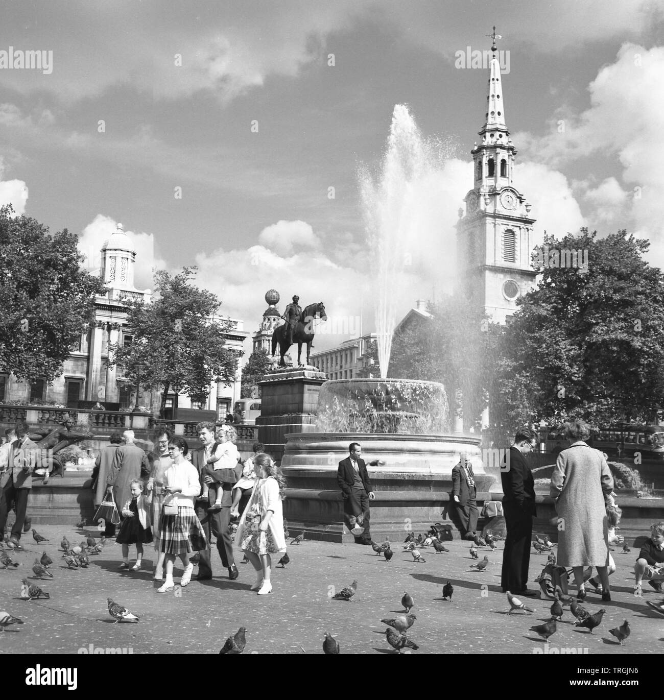 1960, historical, people and pigeons by the fountains at Trafalgar ...