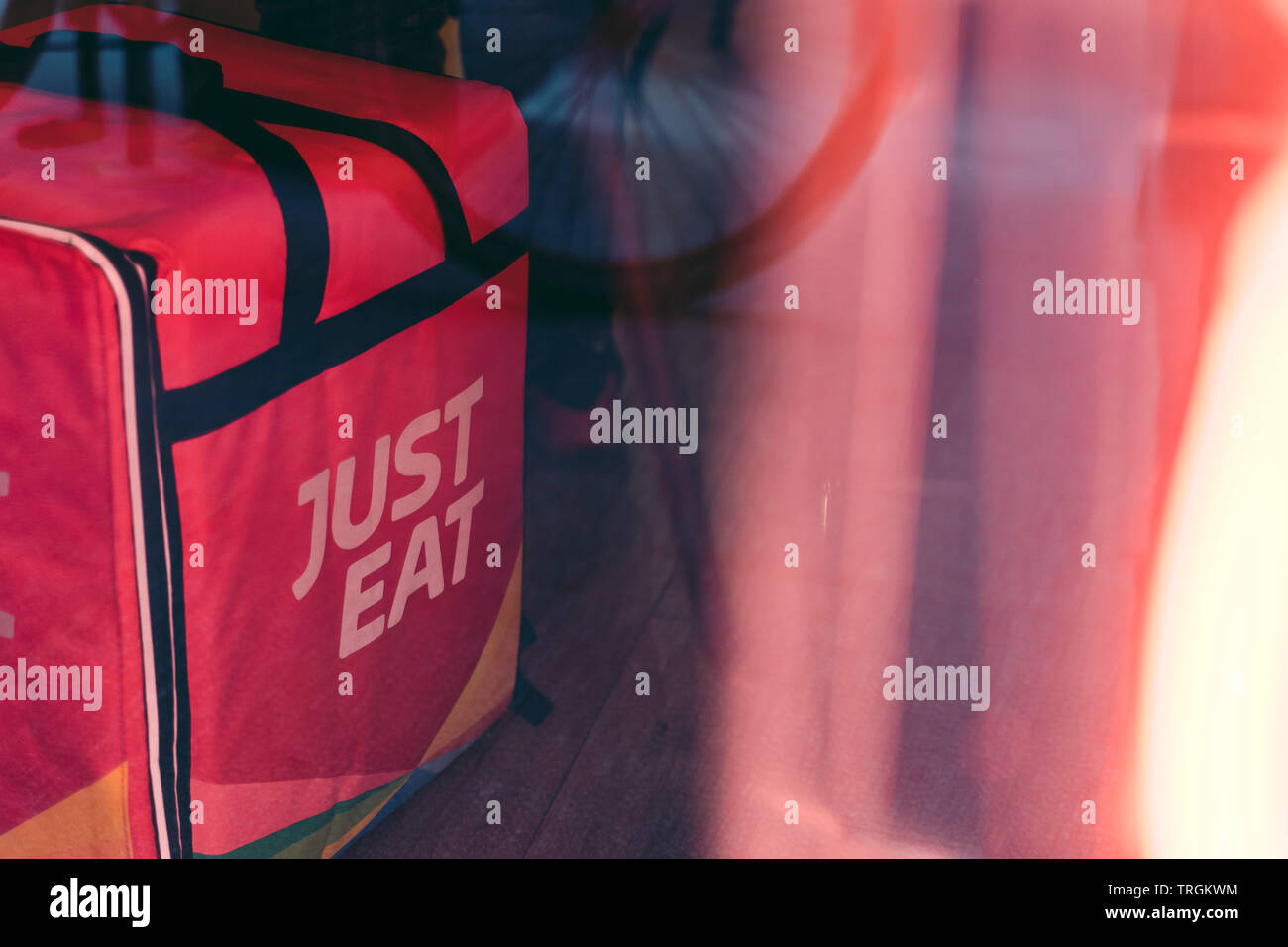 Valencia, Spain - June 1, 2019:: Just Eat  logo Colored logo on the backpack. Online food ordering, home delivery service. Food take away. Stock Photo
