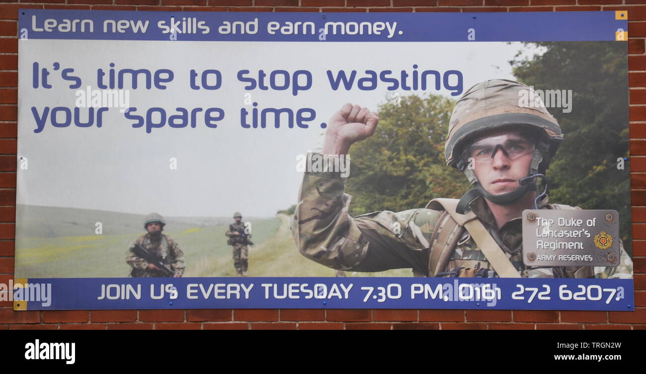 A banner invites people to join the Duke of Lancashire's Regiment Territorial Army in Ardwick, Manchester, uk Stock Photo