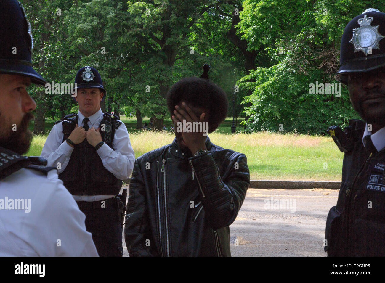 London UK 3rd June 2019 Police stop and search a man on the Mall near Buckingham Palace before Donald Trump's arrival to Buckingham Palace. Stock Photo