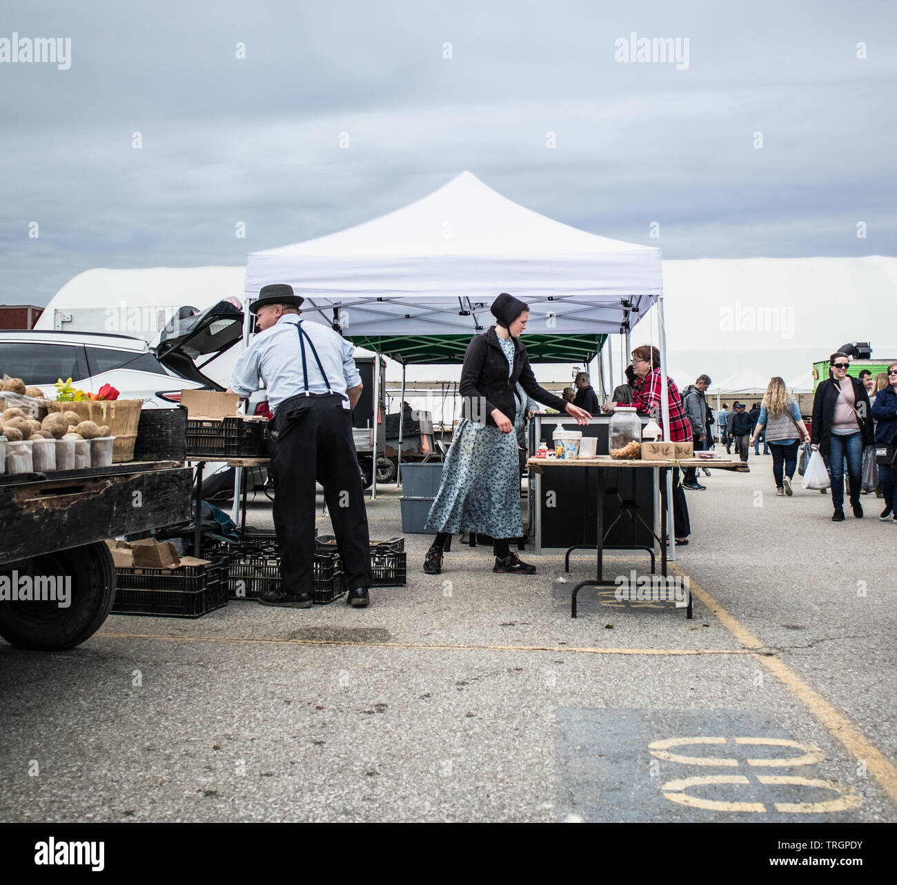 At the St. Jacobs Market, Waterloo region, Ontario. A male and female from the Mennonite community selling their products. Stock Photo