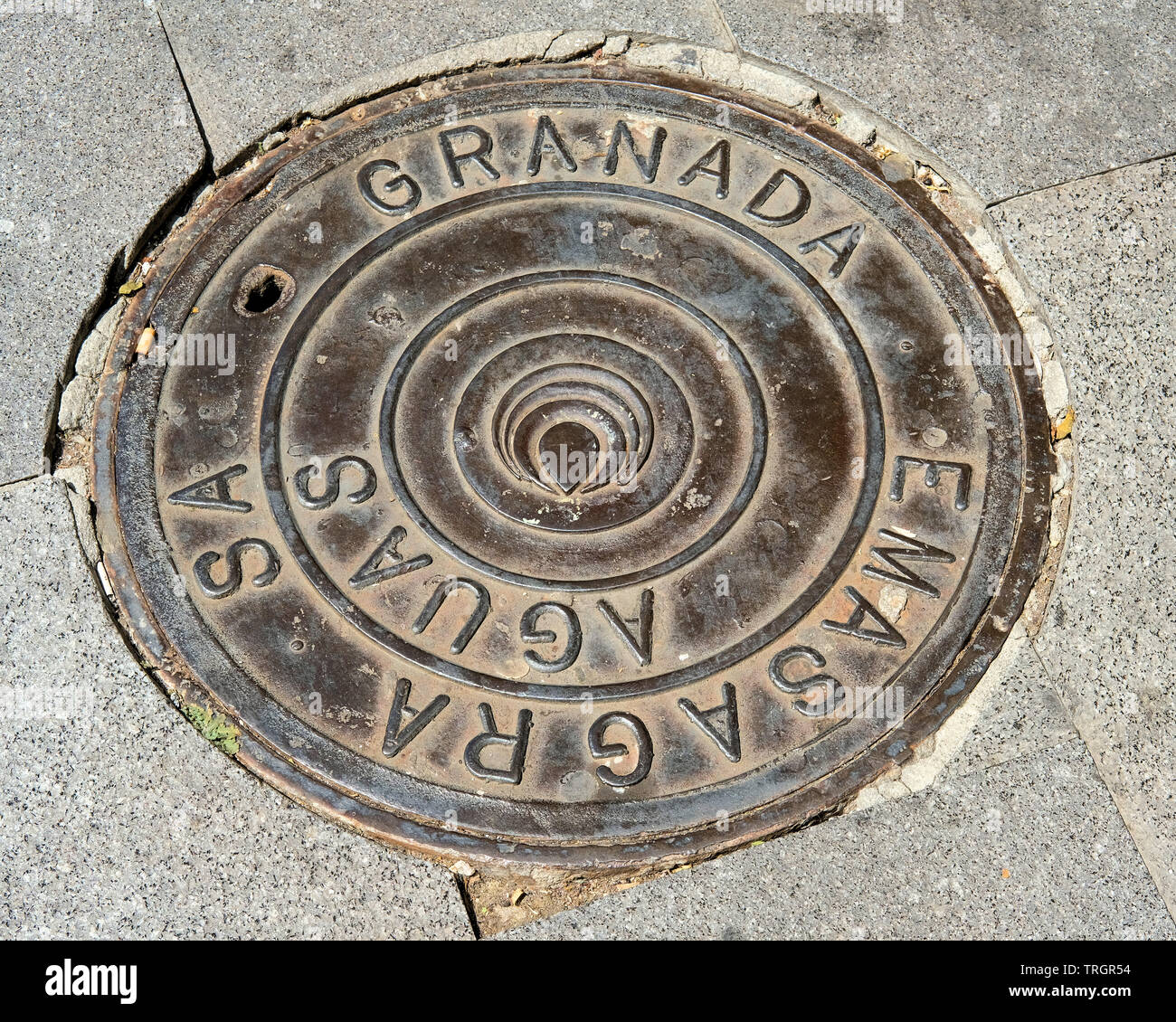 Emsagra circular drain man hole cover in Granada, Spain. Stock Photo
