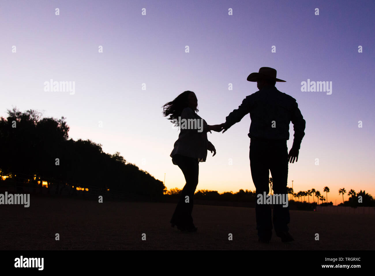 Country Family in the sunset dancing and jumping Stock Photo