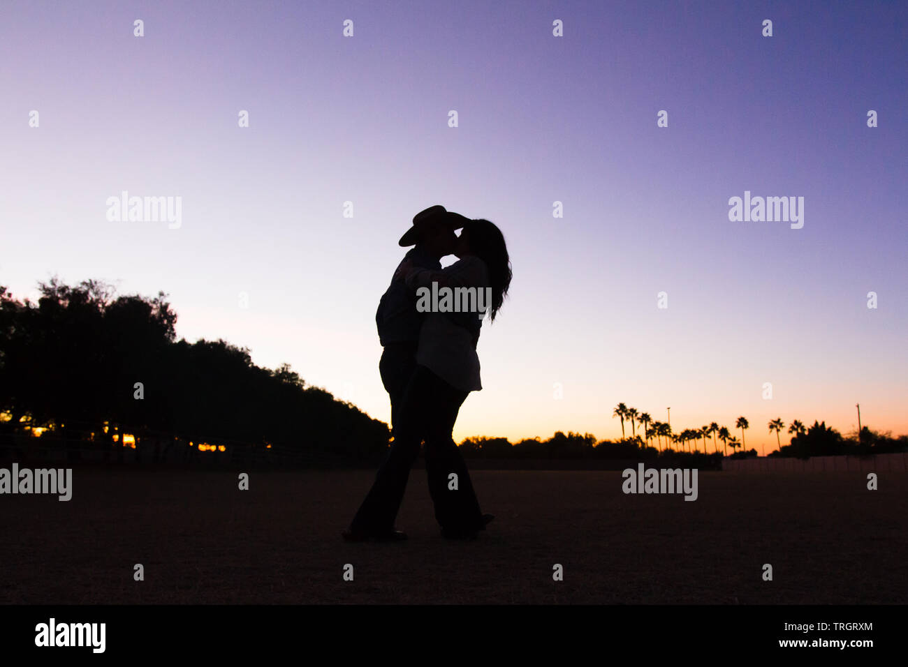 Country Family in the sunset dancing and jumping Stock Photo