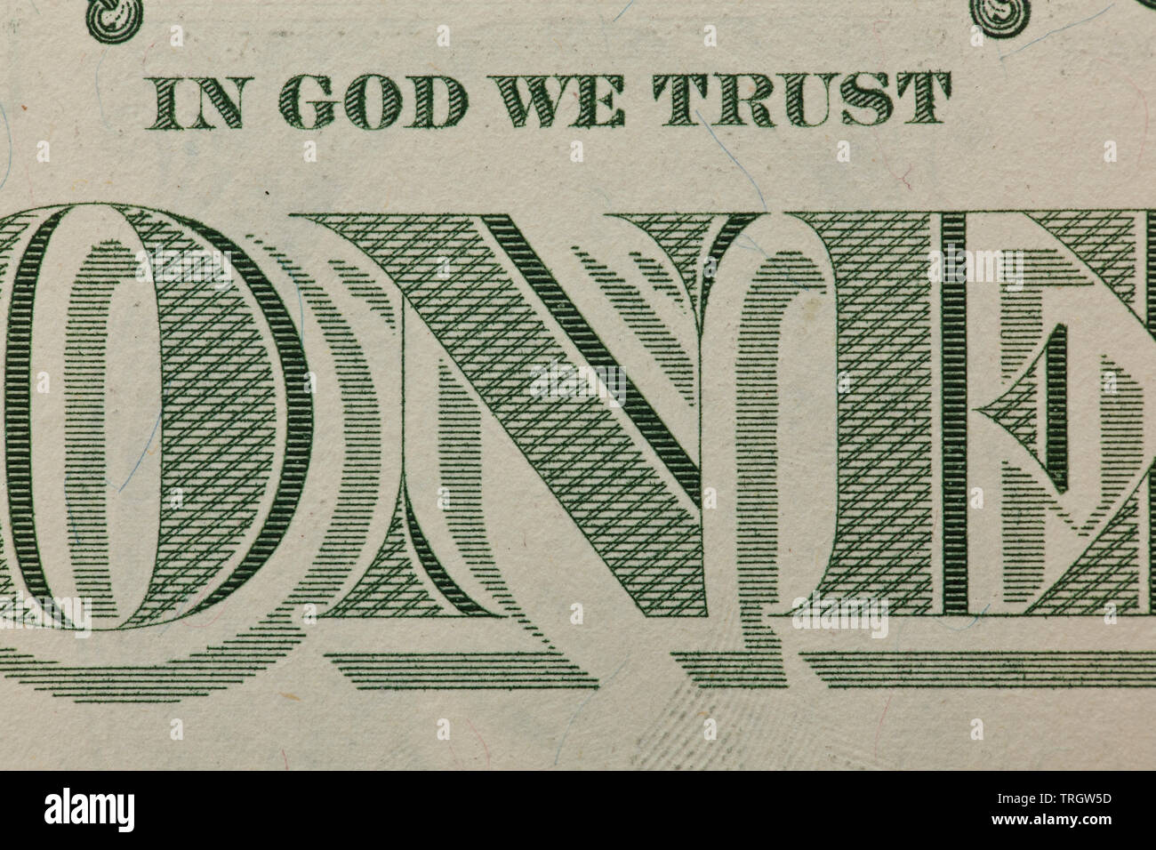 One Dollar bill with focus on the ONE on back and In God We Trust Stock Photo