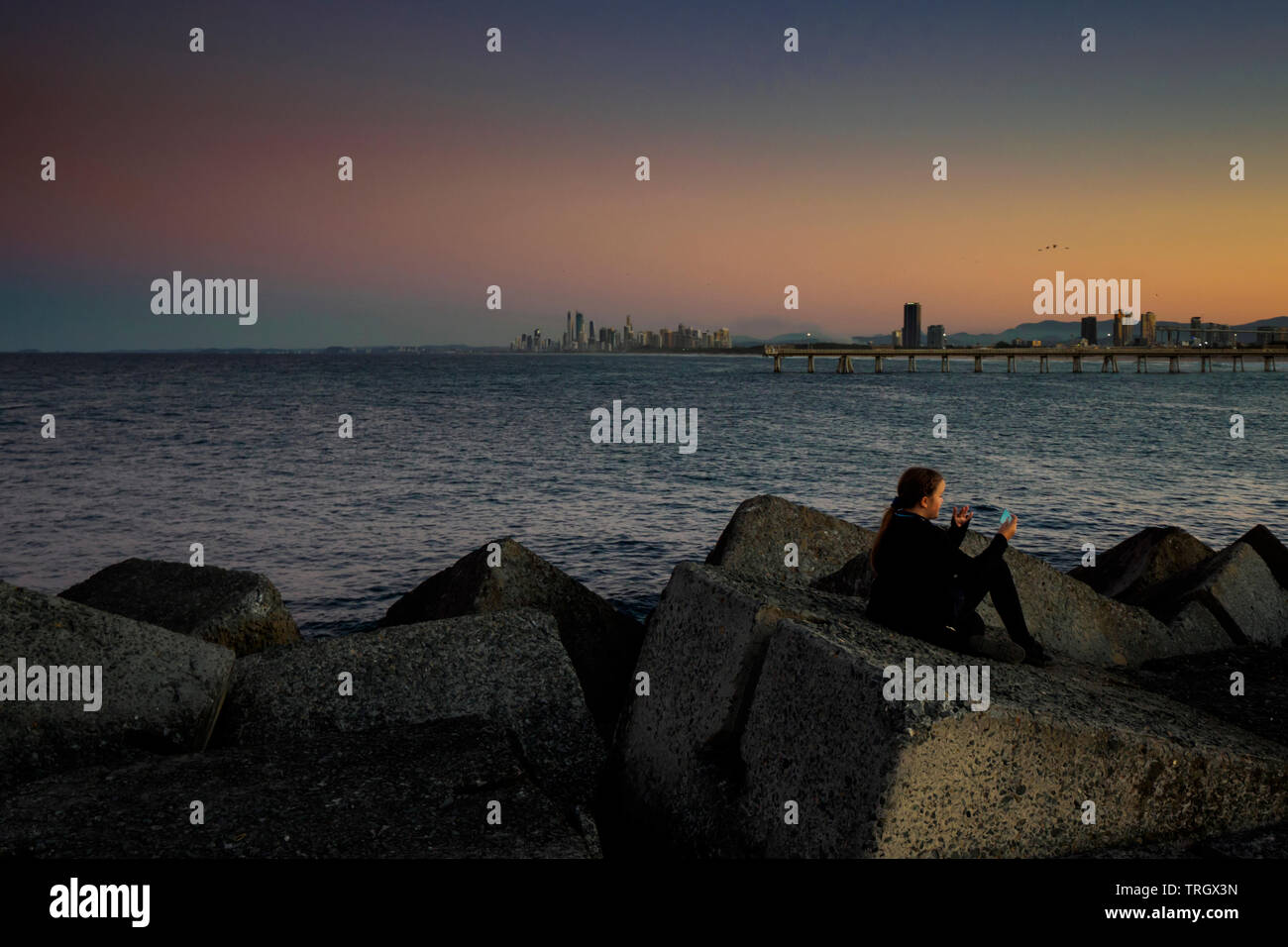 girl taking selfie at sunset gold coast queensland Stock Photo