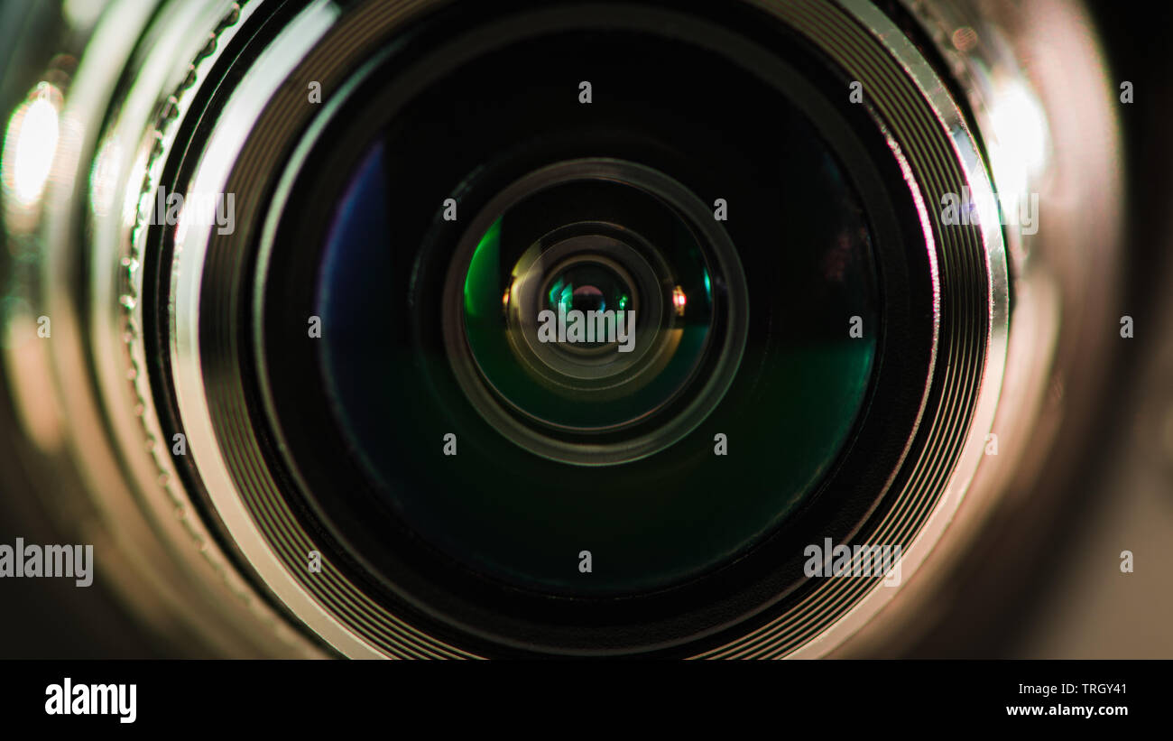 Camera lens and beautiful multi-colored silver backlight Stock Photo