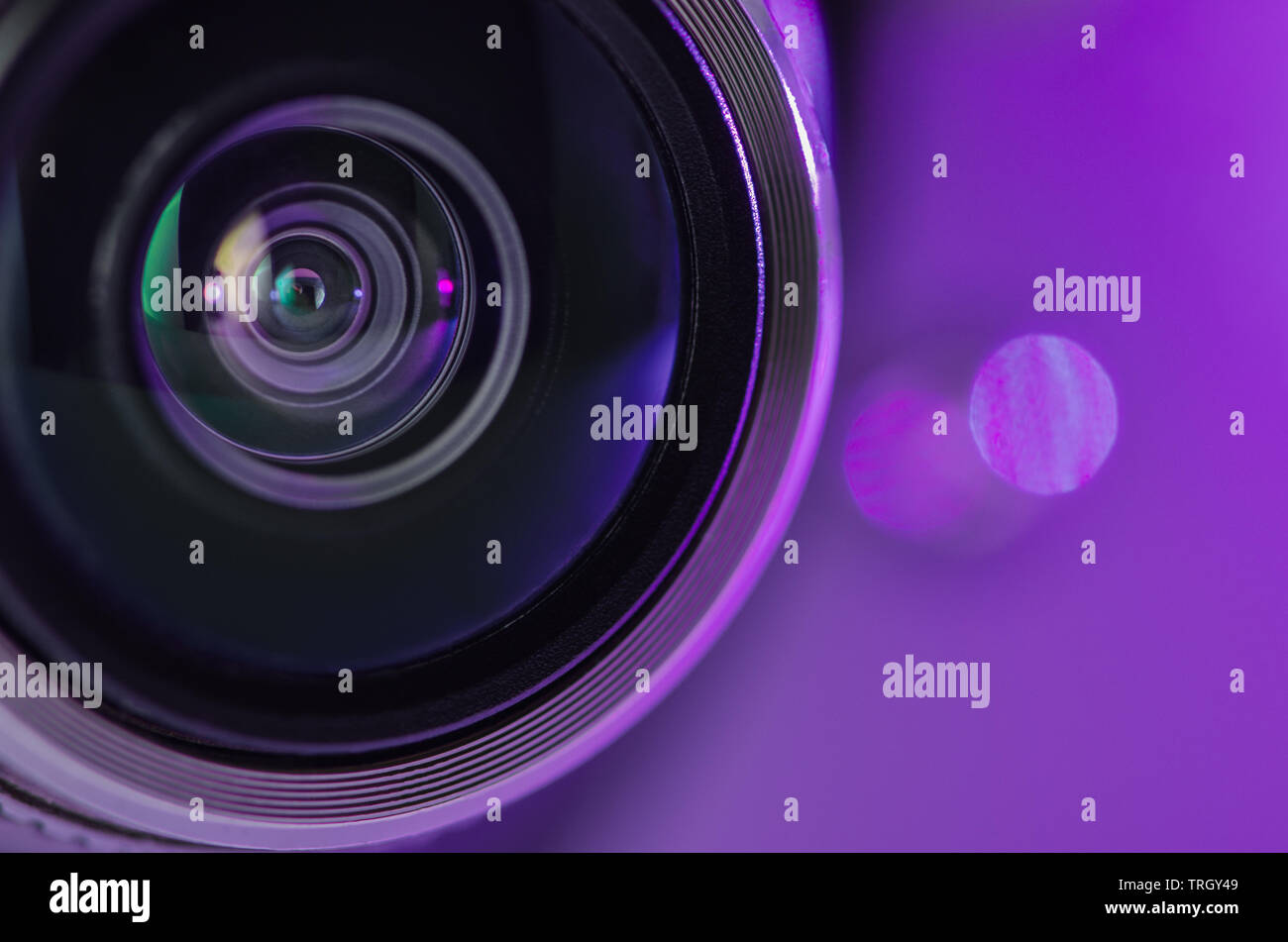 The camera lens and beautiful lighting lilac color . Horizontal photo Stock Photo