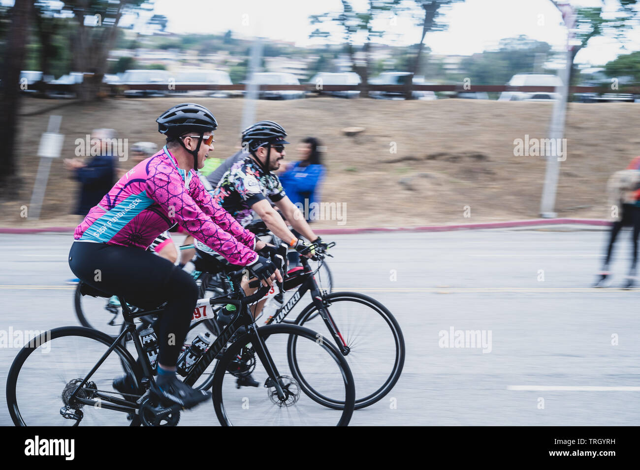 San Francisco, USA. 2nd June, 2019. Two cyclists leaving the Cow Palace at the start of the AIDS/Lifecycle, the 7 day 545-mile ride from SF to LA Stock Photo