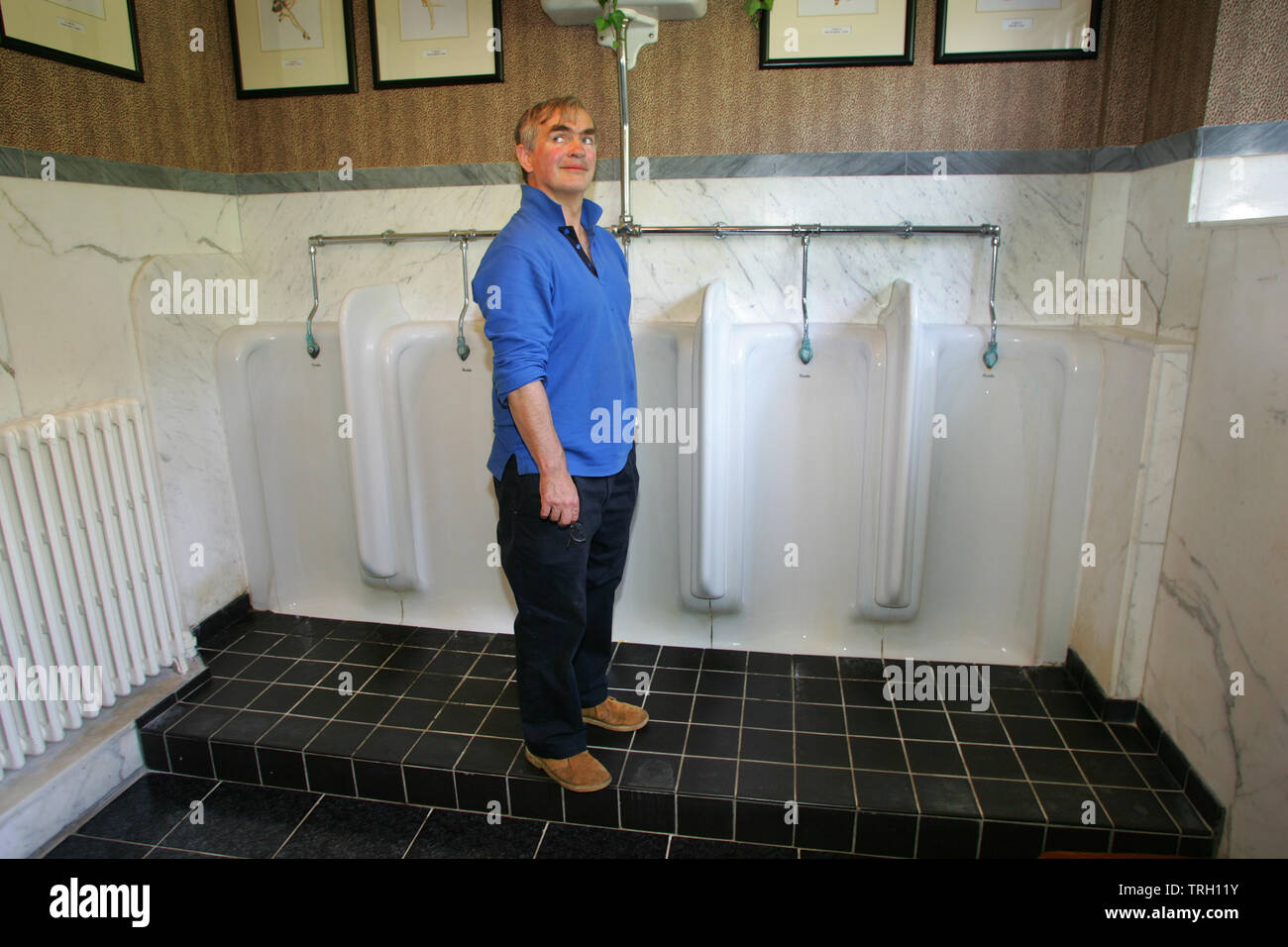 27.06.2005 - Fulford Manor & Bovey Castle, Devon. Francis Fulford takes a look inside the gents toilets at the plush Bovey Castle. Stock Photo