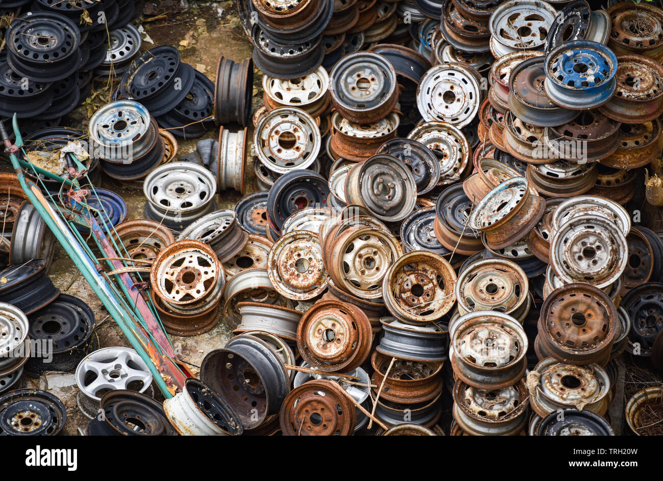 scrap metal / heap of old rusty metal wheel rims in the car dum wheel
