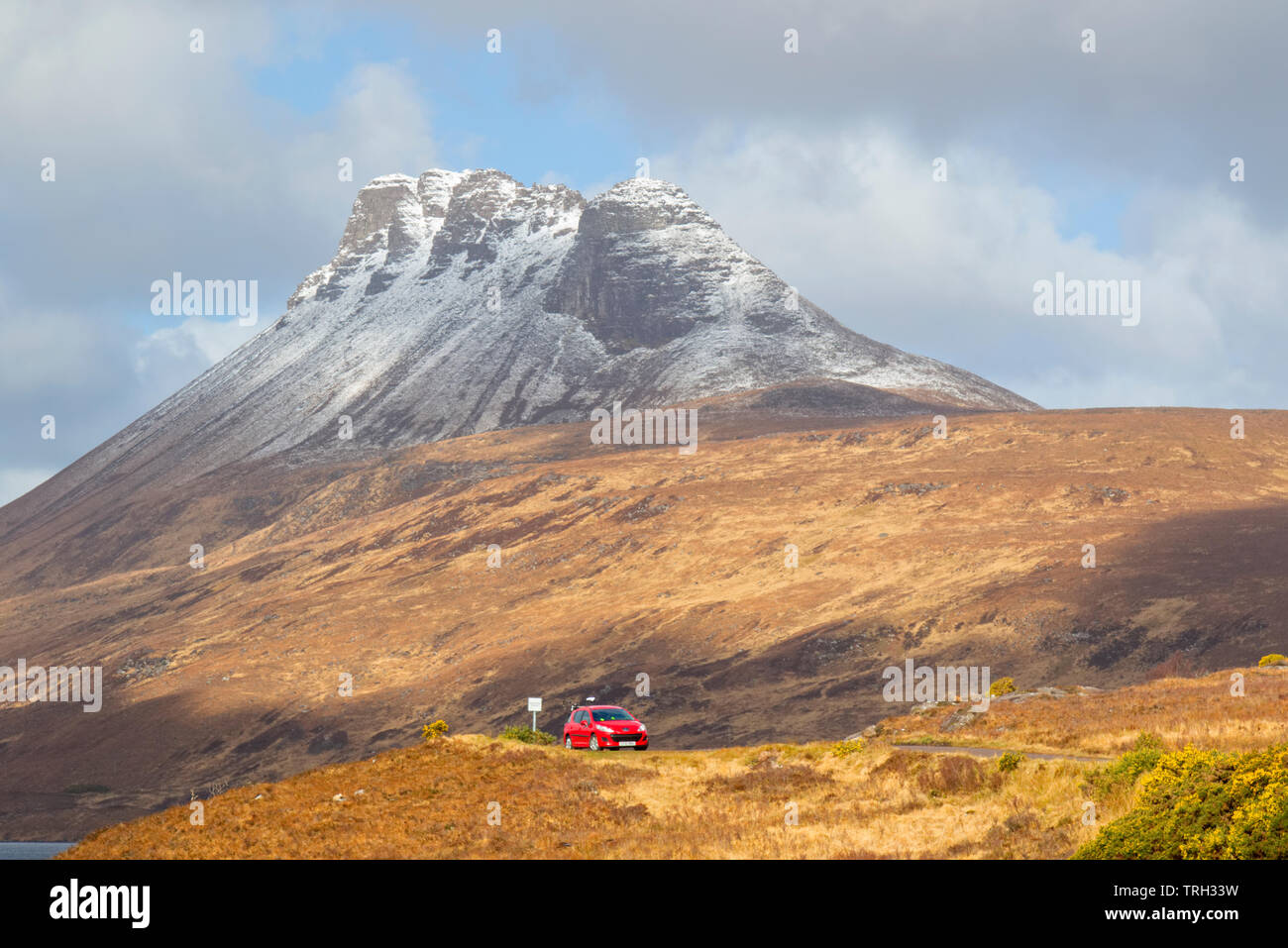 Car on single track road with Stac Pollaidh mountain behind, Wester Ross Stock Photo