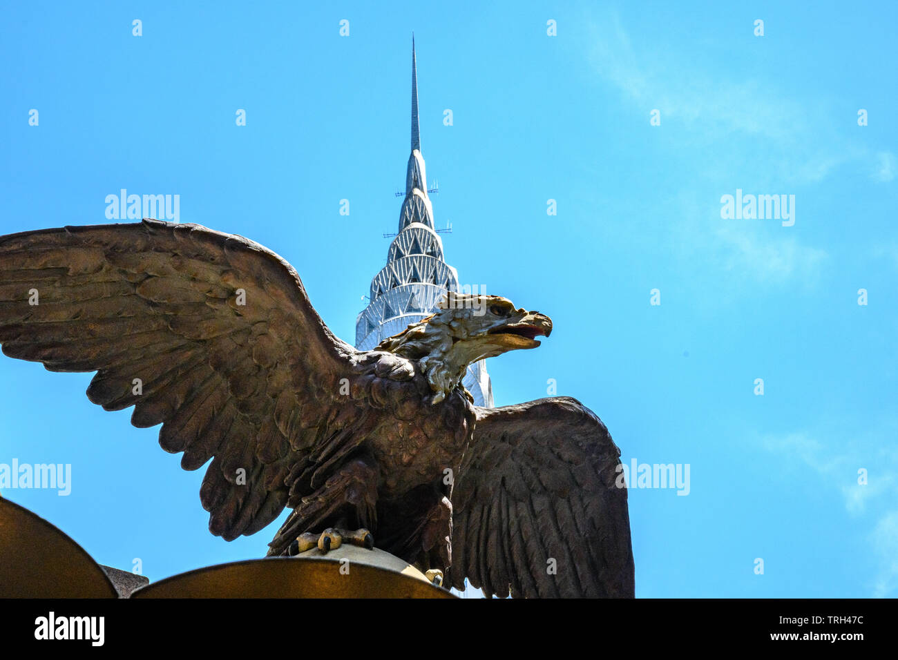 New York, USA,  21 May 2019. A large cast-iron eagle sits atop Grand Central Station in front of the Chrysler building in midtown New York City.  Cred Stock Photo