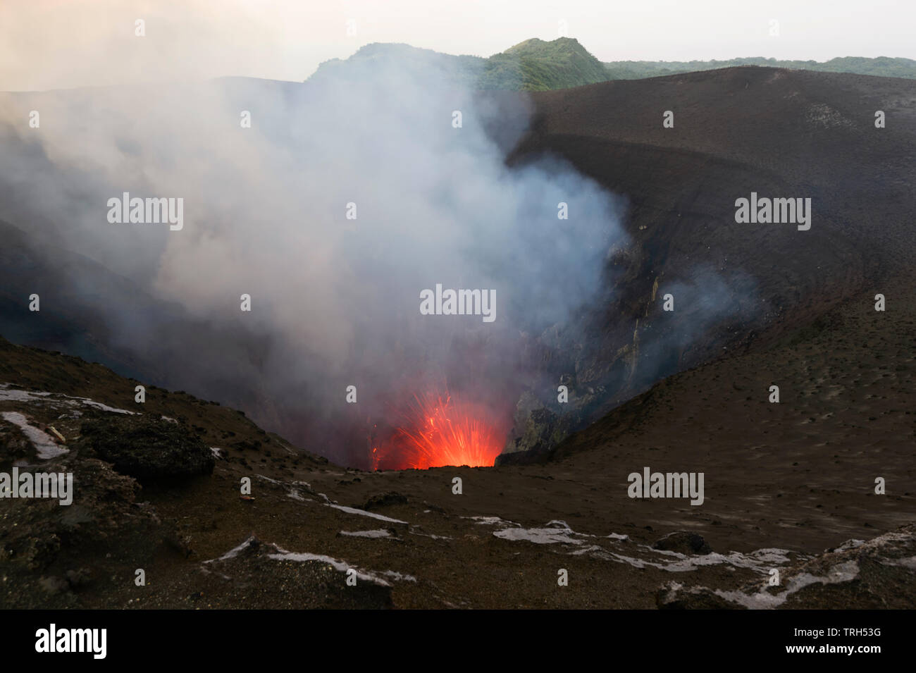 Glowing Lava, fumaroles, hot gases and sparks at erupting Mt Yasur Volcano, Tanna Island, Vanuatu Stock Photo