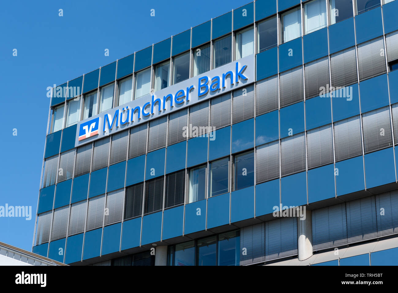 Modern bank building in Munich, Germany with the name Münchner Bank written on the side Stock Photo
