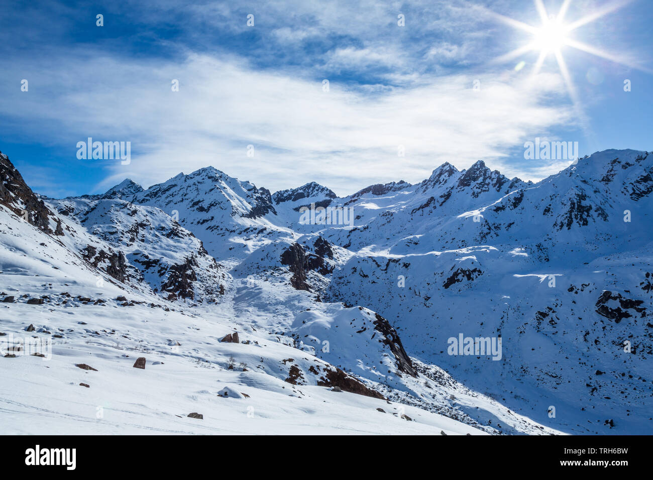 Snow covered mountains in the Talkeetna Mountain Range of Alaska. Snow is melting under a bright spring sun in April near Hatcher Pass Recreation Area Stock Photo