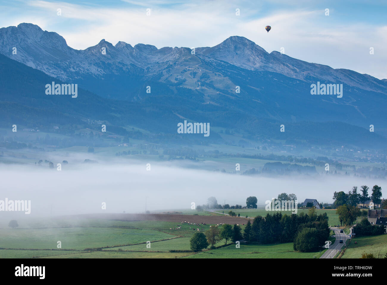 A balloon floating over the mist lying on the Vercors plateau near Villard de Lans, Rhone Alpes, France Stock Photo