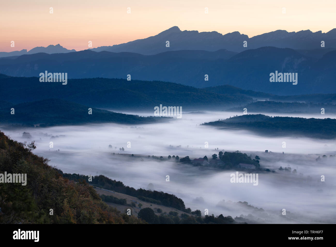 Mist lying on the the Vercors plateau at dawn from above Vassieux, Drôme, France Stock Photo