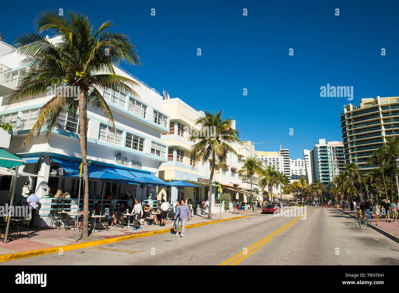 MIAMI - JANUARY 12, 2018: Pastel-trimmed Art Deco buildings line an empty Ocean Drive on a quiet morning in South Beach. Stock Photo