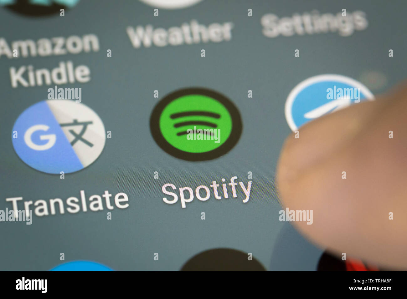 Spotify logo icon on mobile phone screen Stock Photo