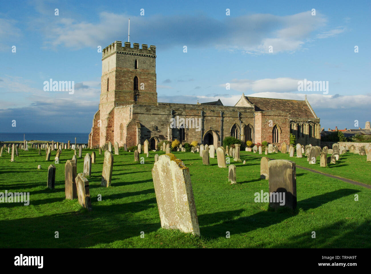 St Aidan's a grade I listed church in the seaside village of Bamburgh, Northumberland; the earliest parts of the building date from the 12th century Stock Photo