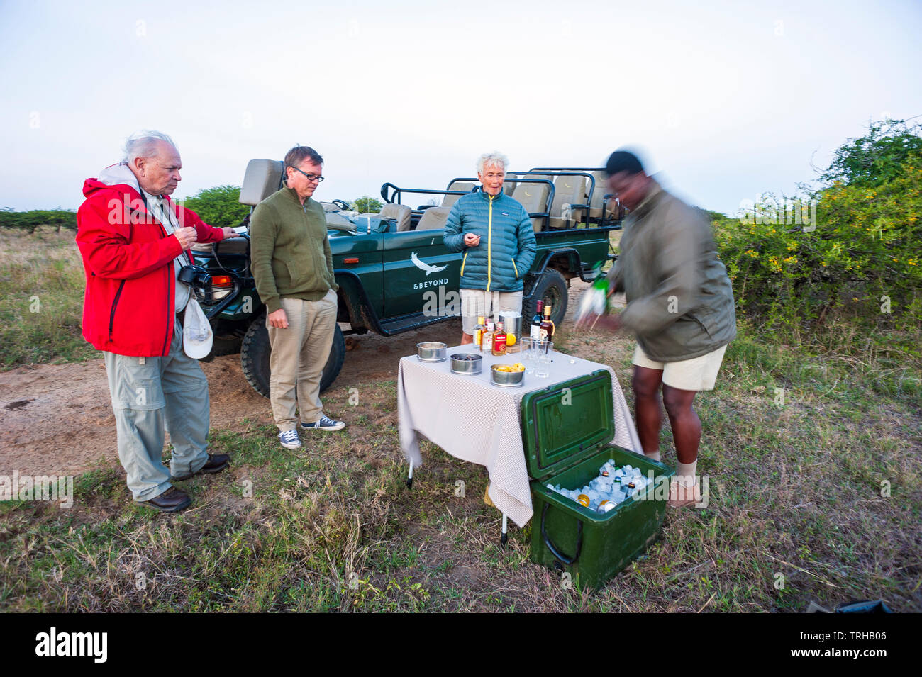 Tourists stop for cocktails while on safari at the Phinda Private Game Reserve, an andBeyond owned nature reserve in eastern South Africa. Stock Photo