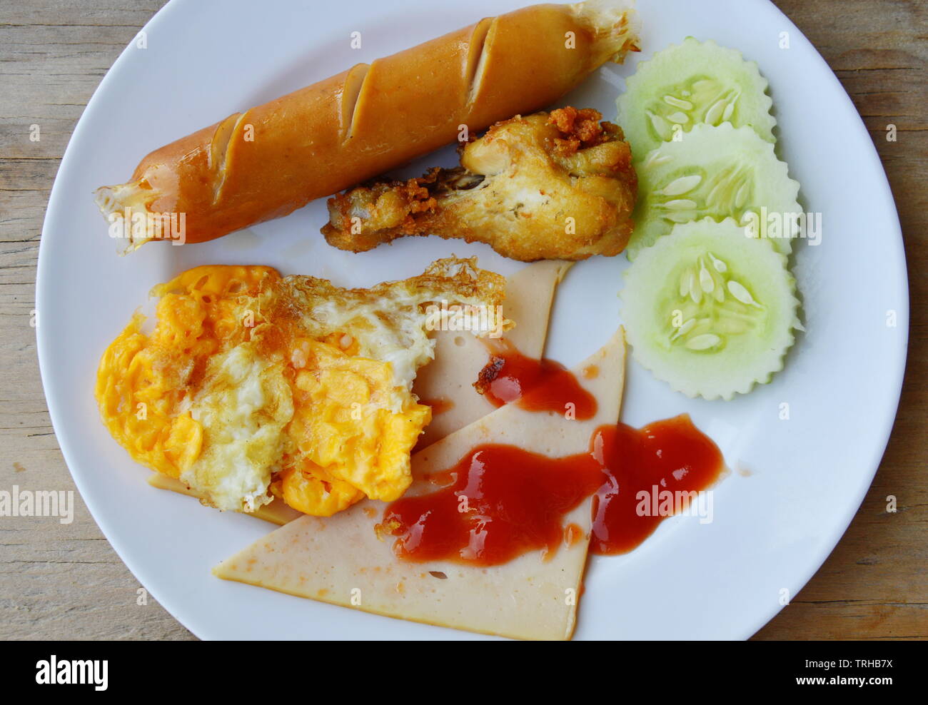 deep fried egg and sausage dressing ketchup on plate Stock Photo Alamy