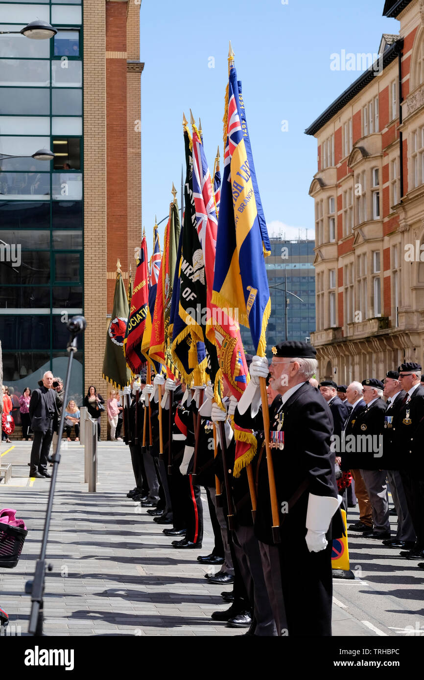 Newport, Wales, UK, 6th June 2019. Cadets, current and former servicemen parade through the city to commemorate the 75th anniversary of the D-Day invasion. The annual parade is organised by the Royal Welsh Comrades Association. Banners were held proudly aloft, and medals worn as they marched to the D-Day memorial. Newport’s memorial commemorates the men of the 2nd Battalion Welsh Borderers who landed on Gold Beach Normandy.  Credit: Mr Standfast/Alamy Live News Stock Photo