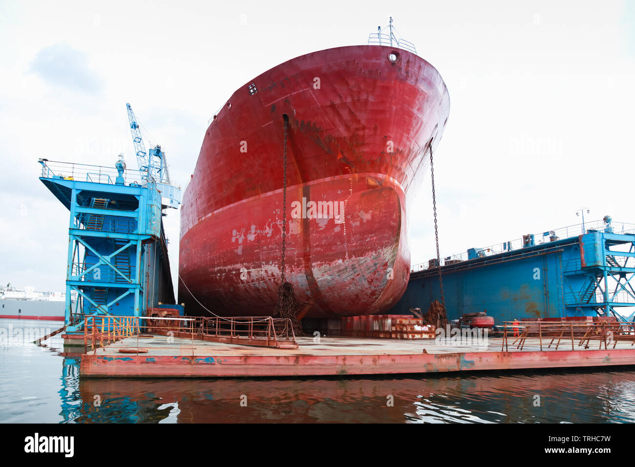 Huge red tanker is under repairing in dry dock. Shipyard of Varna, Bulgaria Stock Photo