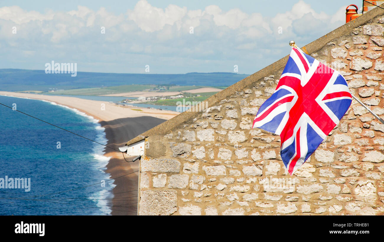 Chesil Beach, Dorset. 6th June 2019. A British Union flag commemorating the 75th anniversary of D-Day is flown from a house in sunny Fortuneswell, overlooking Chesil Beach. Nearby Weymouth and Portland harbours were embarkation points for tens of thousands of U.S. troops heading for 'Omaha' beach in Normandy, France, on 6th June 1944. credit: stuart fretwell/Alamy Live News Stock Photo