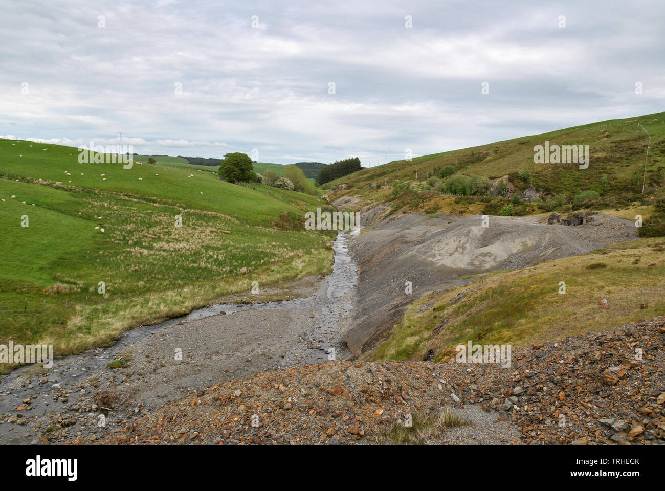 A river flows next to Dylife old lead mine workings in Wales Stock Photo