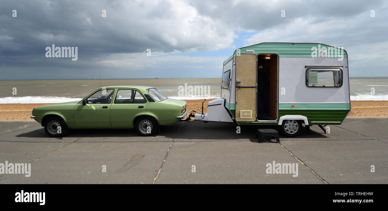 Classic Green Vauxhall Chevette motor car  & Vintage  Trailer -Caravan parked on seafront promenade. Stock Photo