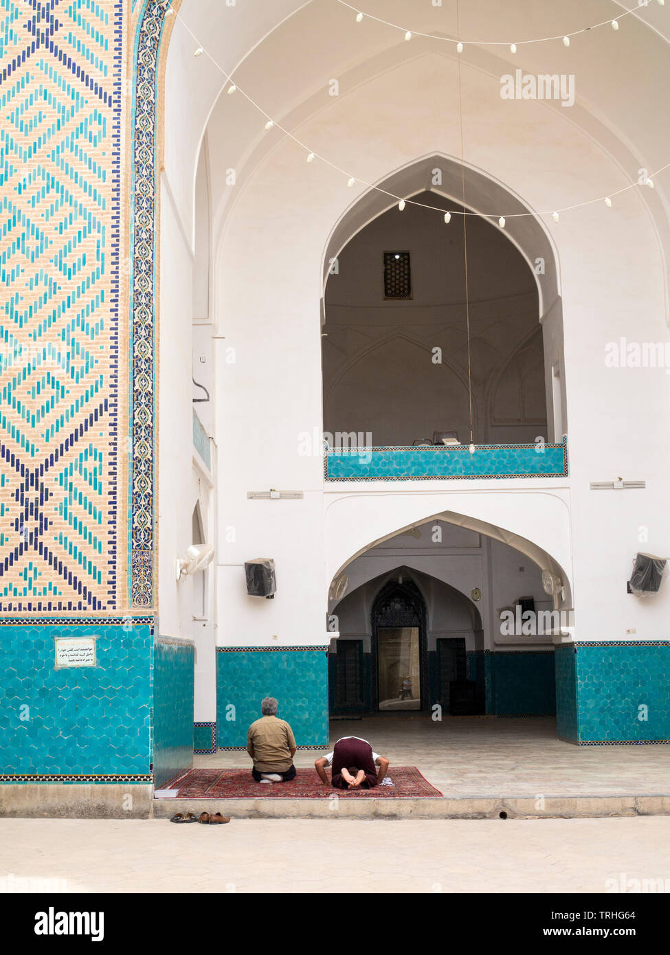 Men praying inside the Amir Chakhmaq mosque in Yazd, Iran. Stock Photo